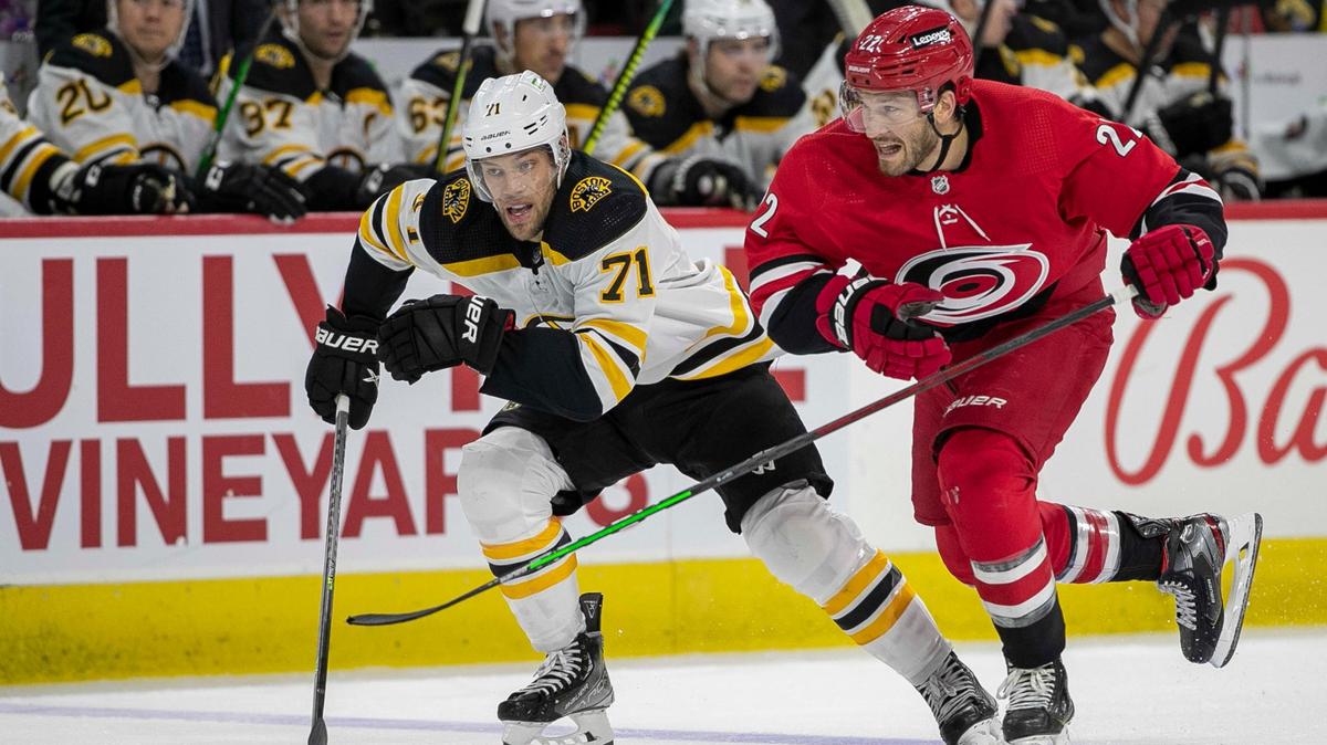 Carolina Hurricanes’ Brett Pesce (22) skates against Boston’s Taylor Hall (71) during the second period on Thursday, October 28, 2021 at PNC Arena in Raleigh, N.C.