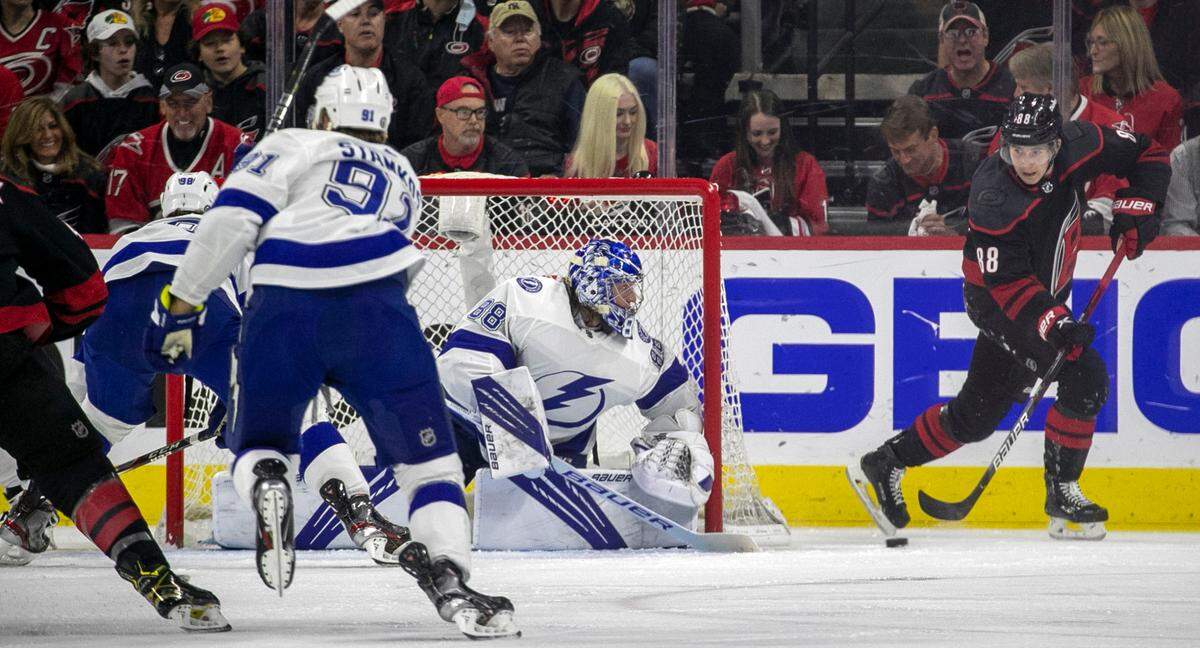 Carolina Hurricanes’ Martin Necas (88) works the puck behind Tampa Bay goalie Andrei Vasilevskiy (88) in the first period during game one of their second round Stanley Cup series on Sunday, May 30, 2021 at PNC Arena in Raleigh, N.C.