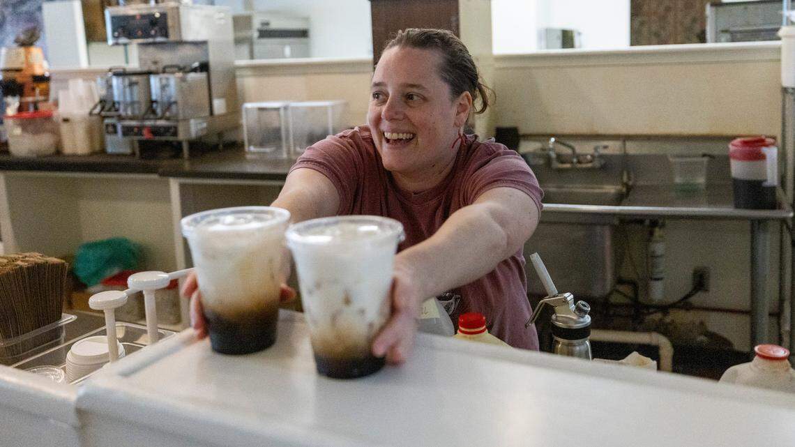 Co-owner Andi Macko serves cold coffee drinks during the reopening of Cup-A-Joe’s Mission Valley location in Raleigh on Tuesday, June 24, 2025. The café closed in 2021 during the pandemic. Its soft-opening pop-up runs through Friday, June 27, from 8 a.m. to 1 p.m. The shop will close Friday afternoon and reopen Aug. 11.