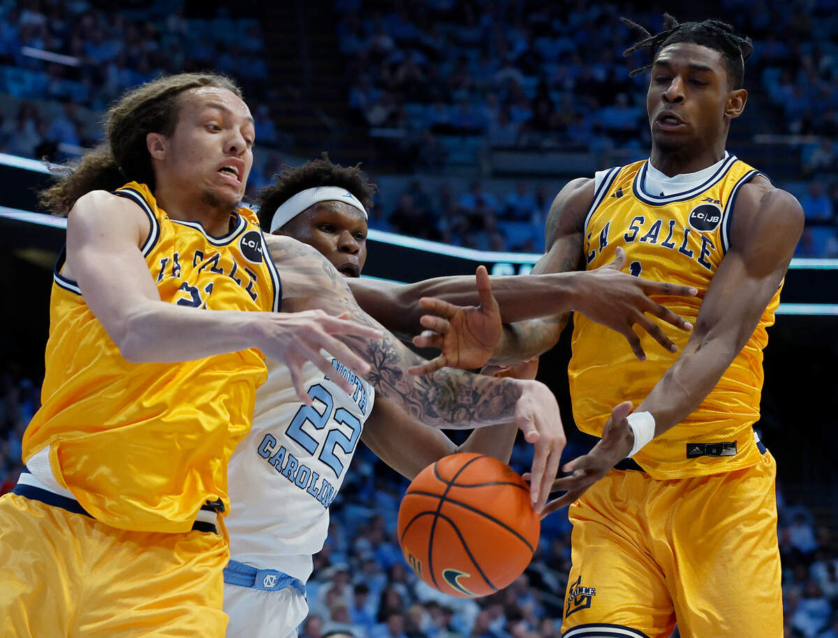 North Carolina’s Ven-Allen Lubin battles for a rebound with La Salle’s Mac Etienne and Jahlil White during the first half of the Tar Heels’ 93-67 win on Saturday, Dec. 14, 2024, at the Smith Center in Chapel Hill, N.C.