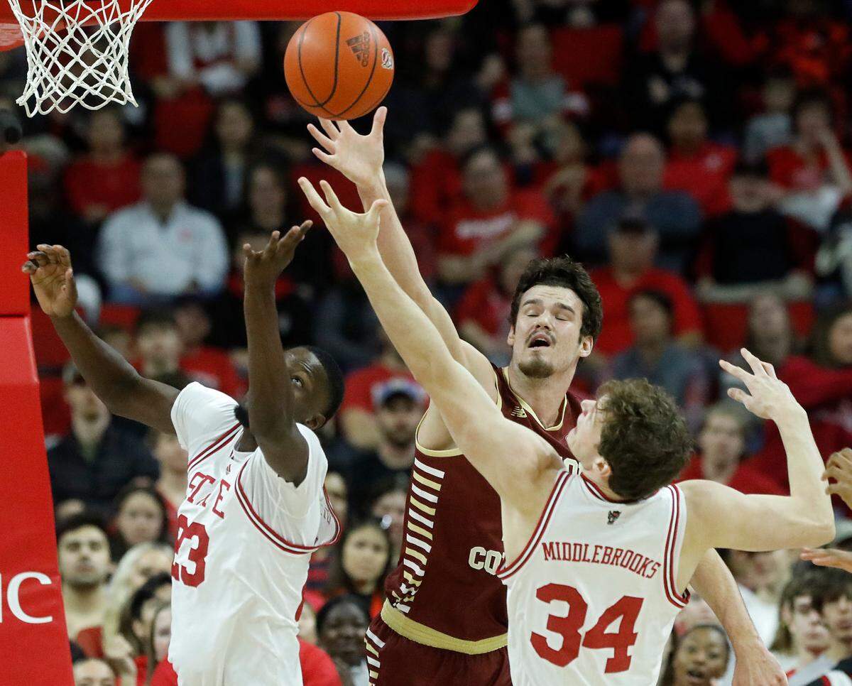 N.C. State’s Mohamed Diarra and Ben Middlebrooks vie for a loose ball with Boston College’s Quinten Post during the first half of the Wolfpack’s 81-70 win on Saturday, Feb. 24, 2024, at PNC Arena in Raleigh, N.C.