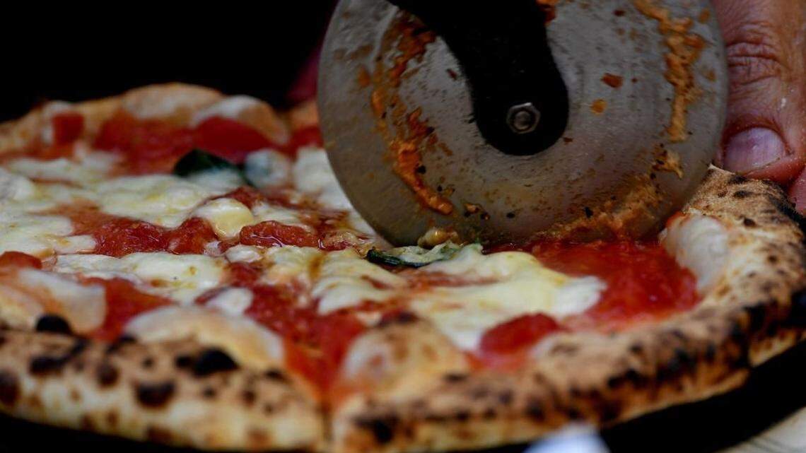 A picture shows a pizza cooked at the Capodimonte museum hosting the first stone oven where was cooked a Pizza Margherita, on December 6, 2017 in Naples. Naples' art of pizza twirling is a candidate to join UNESCO's list of "intangible heritage" and the city is waiting for the decision of the UN cultural body's World Heritage Committee which is reunited in South Korean island of Jeju this week. / AFP PHOTO / TIZIANA FABI (Photo credit should read TIZIANA FABI/AFP via Getty Images)