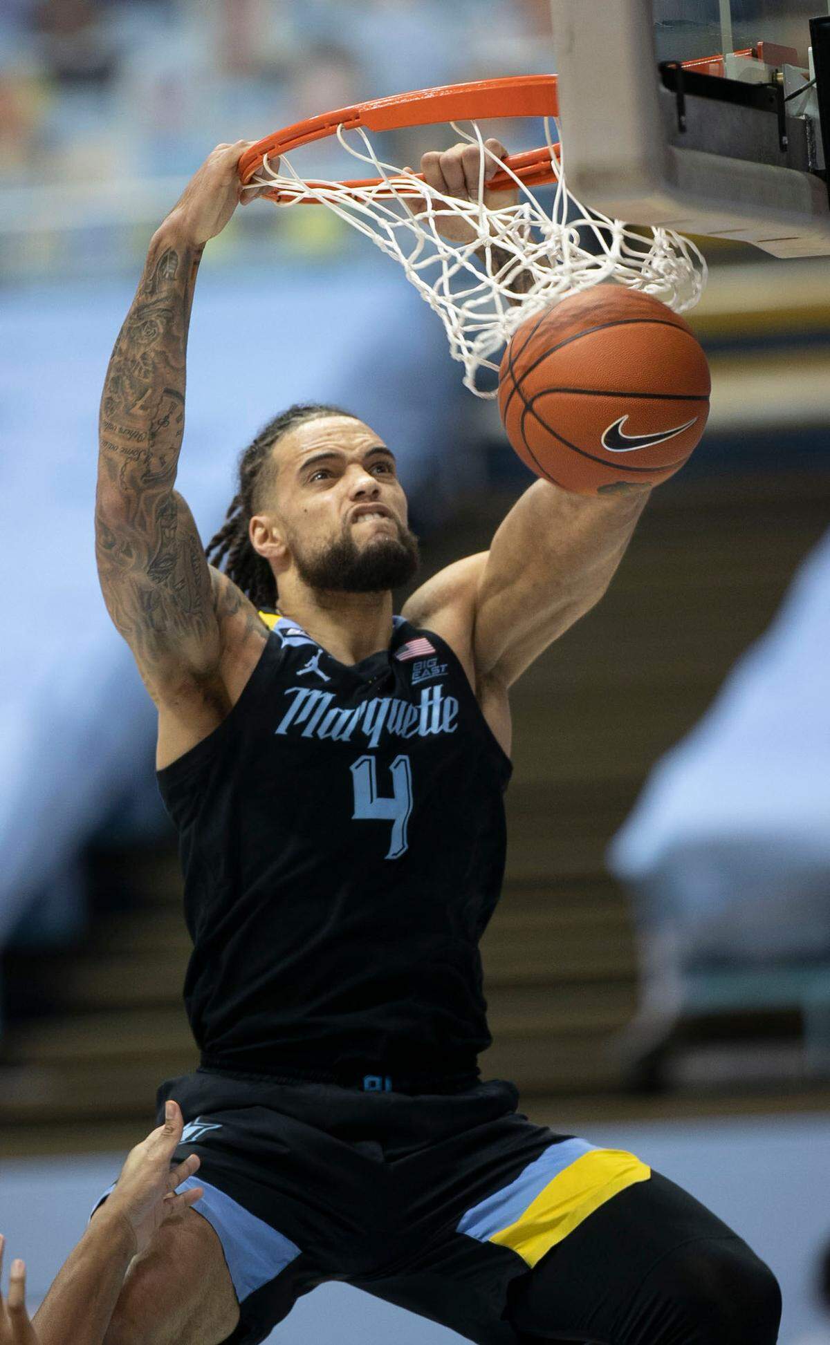 Marquette’s Theo John (4) gets a dunk in the second half against North Carolina on Wednesday, February 24, 2021 at the Smith Center in Chapel Hill, N.C.