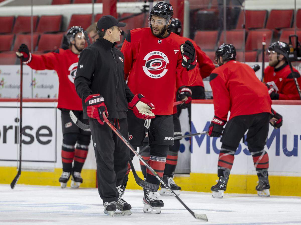 Carolina Hurricanes coach Rod Brind’Amour talks with defenseman K’Andre Miller (19) during practice on Monday June 1, 2026 at Lenovo Center in Raleigh, N.C.