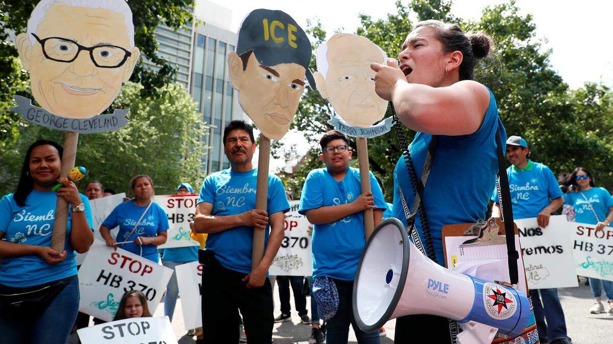 Nikki Marin Baena of Greensboro leads a chant during a 2019 rally to protest bills that would have required law enforcement agencies to cooperate with immigration authorities. The 2023-24 version of the bill, which the legislature is finalizing, would require NC sheriffs to cooperate with ICE.