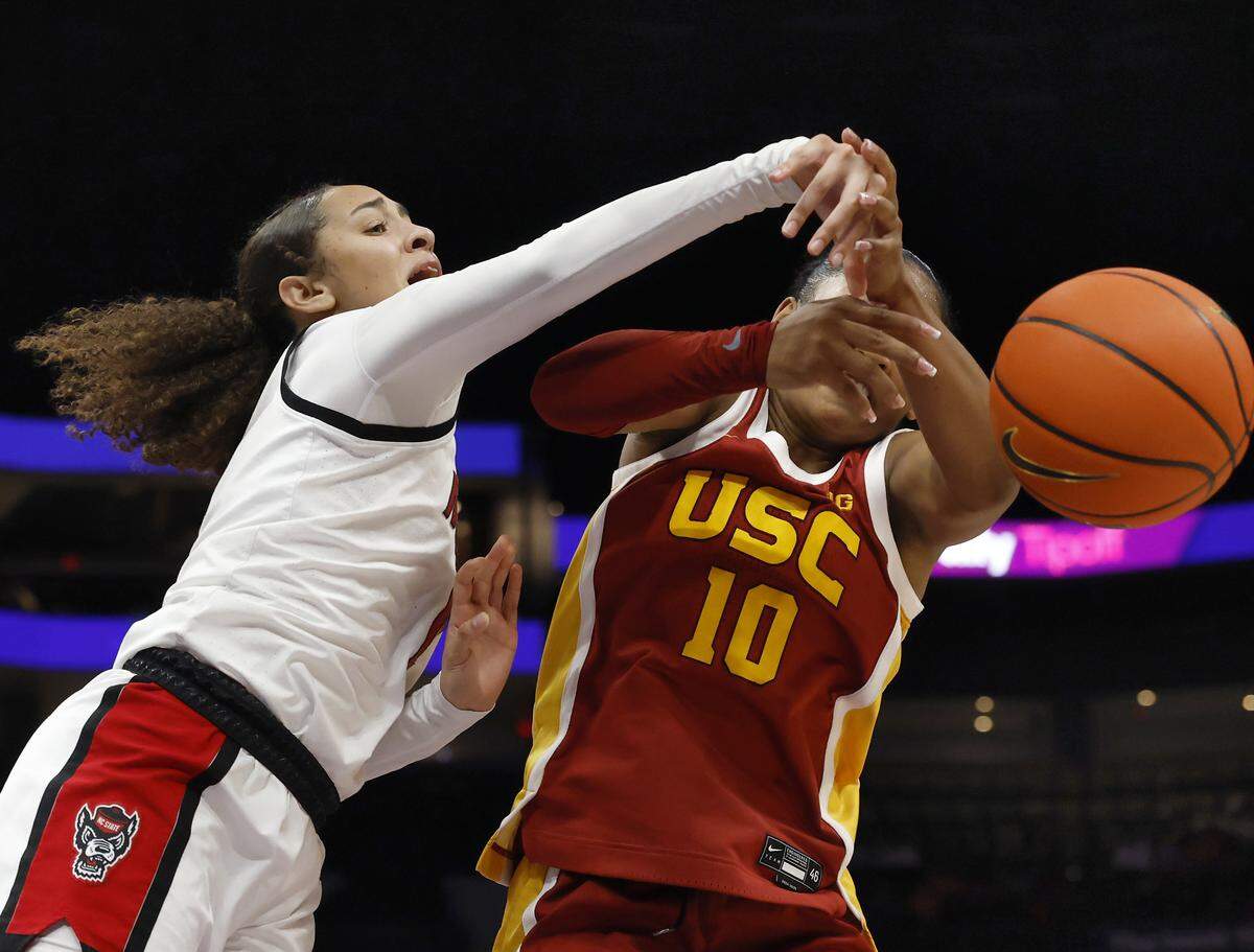 N.C. State’s Devyn Quigley and Southern California’s Malia Samuels battle for a loose ball during the second half of the Wolfpack’s 69-68 loss in the Ally Tipoff game on Sunday, Nov. 9, 2025, at Spectrum Center in Charlotte, North Carolina.