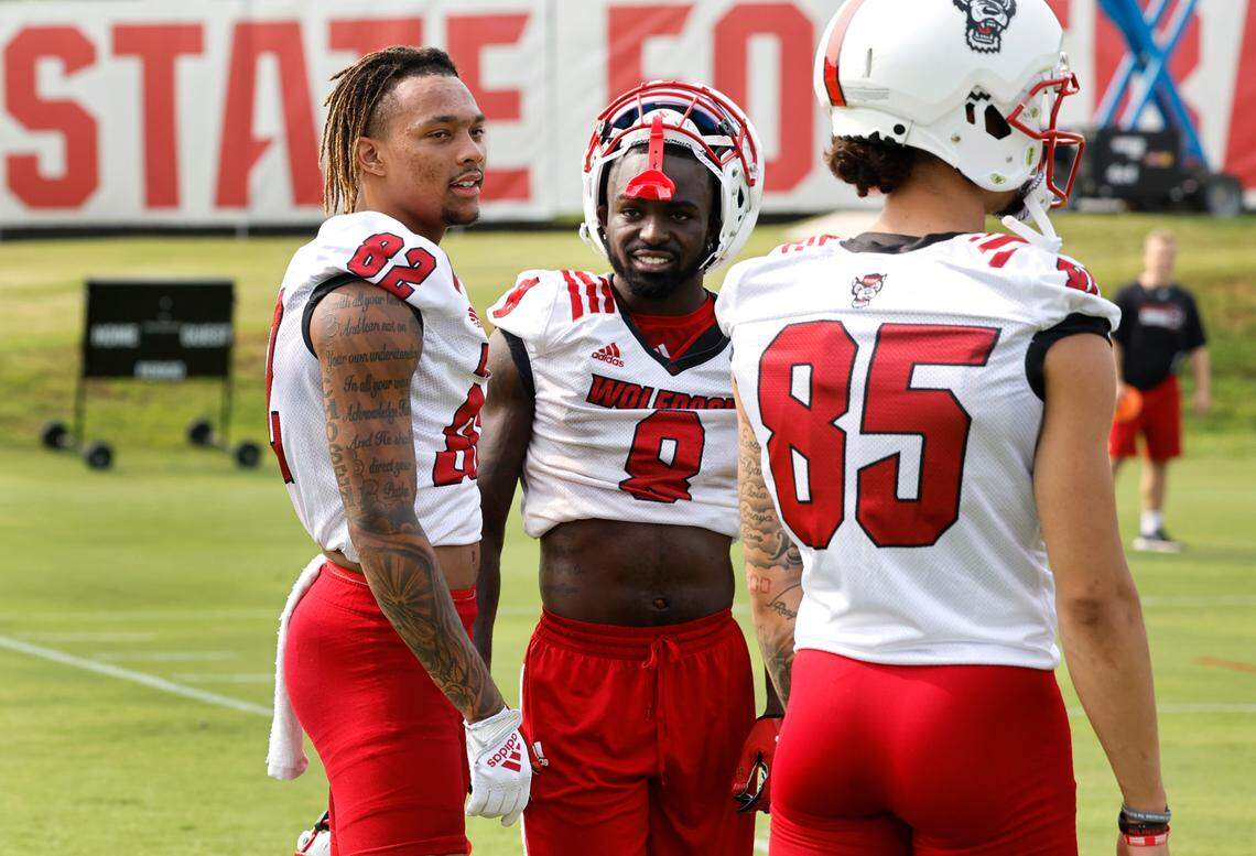 N.C. State wide receiver Terrell Timmons Jr. (82) talks with Julian Gray (8) and Anthony Smith (85) during the Wolfpack’s first fall practice in Raleigh, N.C., Wednesday, August 2, 2023.