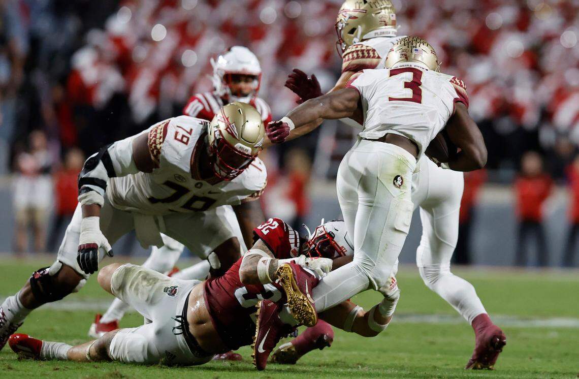 N.C. State linebacker Drake Thomas (32) tackles Florida State running back Trey Benson (3) during the first half of N.C. State’s game against Florida State at Carter-Finley Stadium in Raleigh, N.C., Saturday, Oct. 8, 2022.