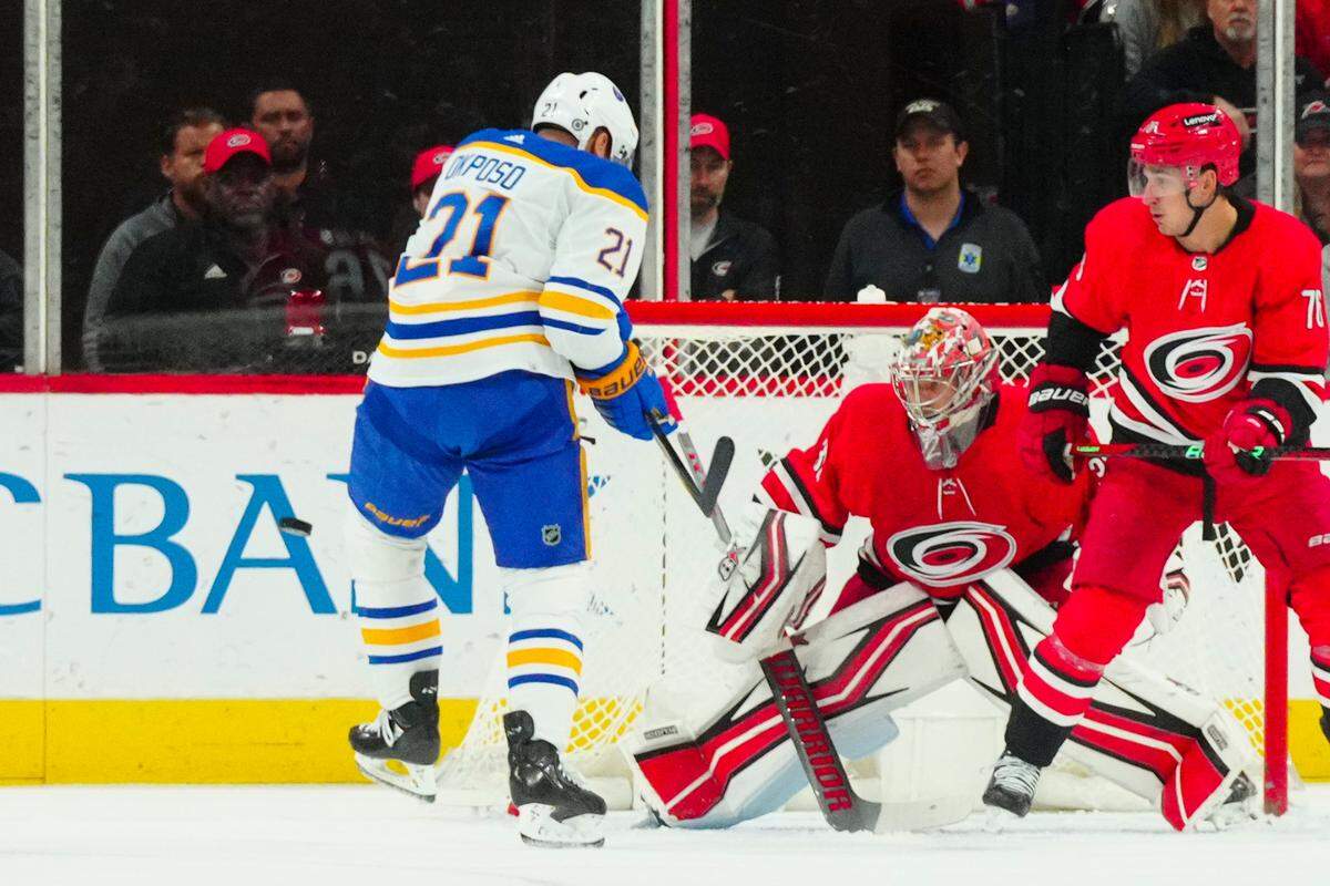 Nov 7, 2023; Raleigh, North Carolina, USA; Carolina Hurricanes goaltender Antti Raanta (32) and Buffalo Sabres right wing Kyle Okposo (21) watch the shot during the first period at PNC Arena. Mandatory Credit: James Guillory-USA TODAY Sports