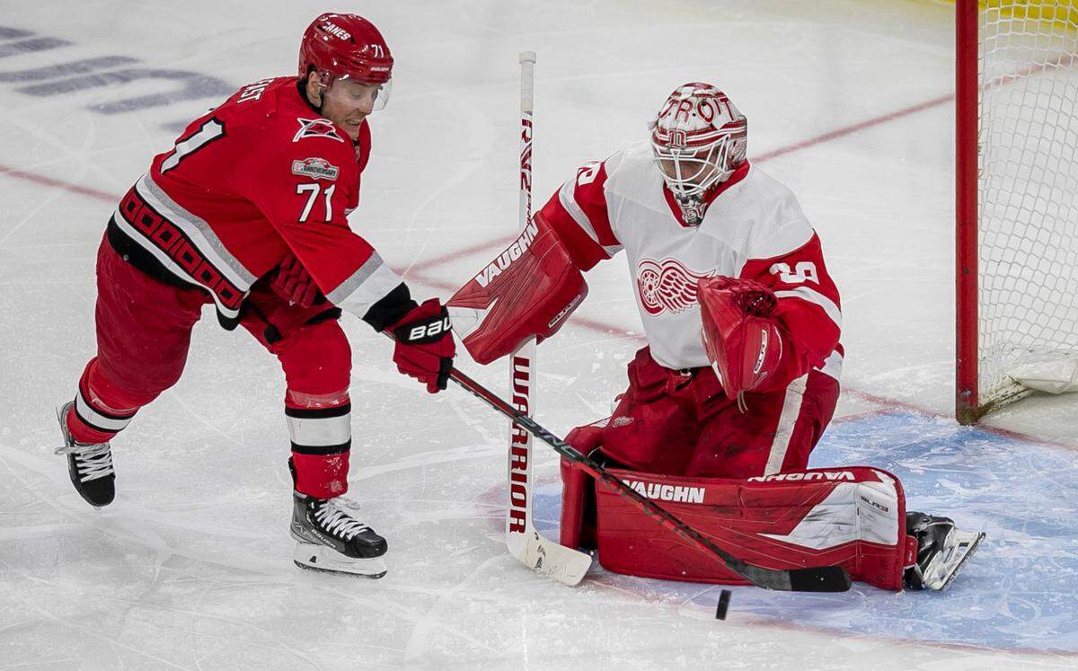 Carolina Hurricanes’ Jesper Fast (71) works the puck against Detroit goalie Alex Nedeljkovic (39) in the second period on Tuesday, April 11, 2023 at PNC Arena in Raleigh, N.C.