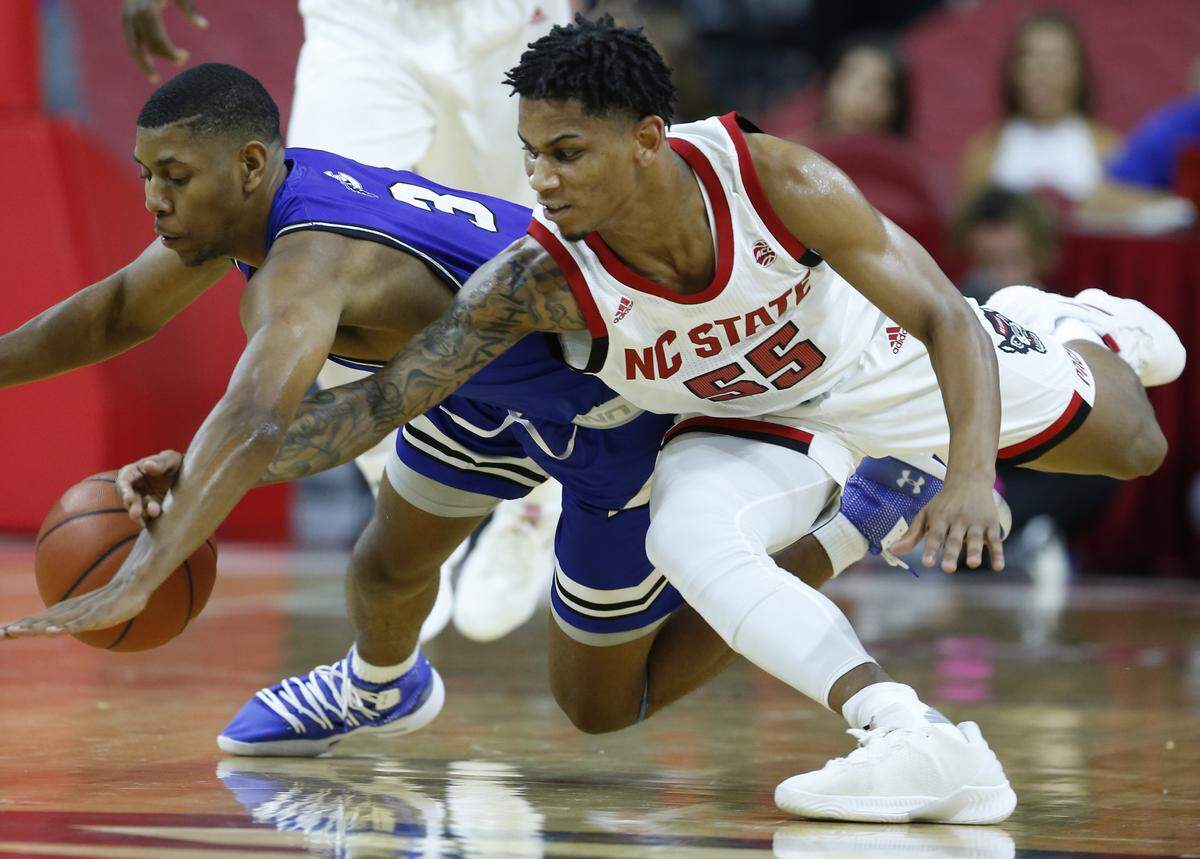 N.C. State’s Blake Harris (55) tries to steal the ball from Chowan’s Brandon Mayhan (3) during the first half of N.C. State’s exhibition game against Chowan at PNC Arena in Raleigh, N.C., Monday, Oct. 29, 2018.