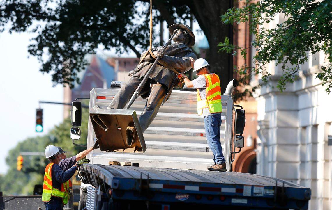 Crews work on removing the North Carolina Confederate monument at the North Carolina State Capitol in Raleigh, N.C., Sunday, June 21, 2020.