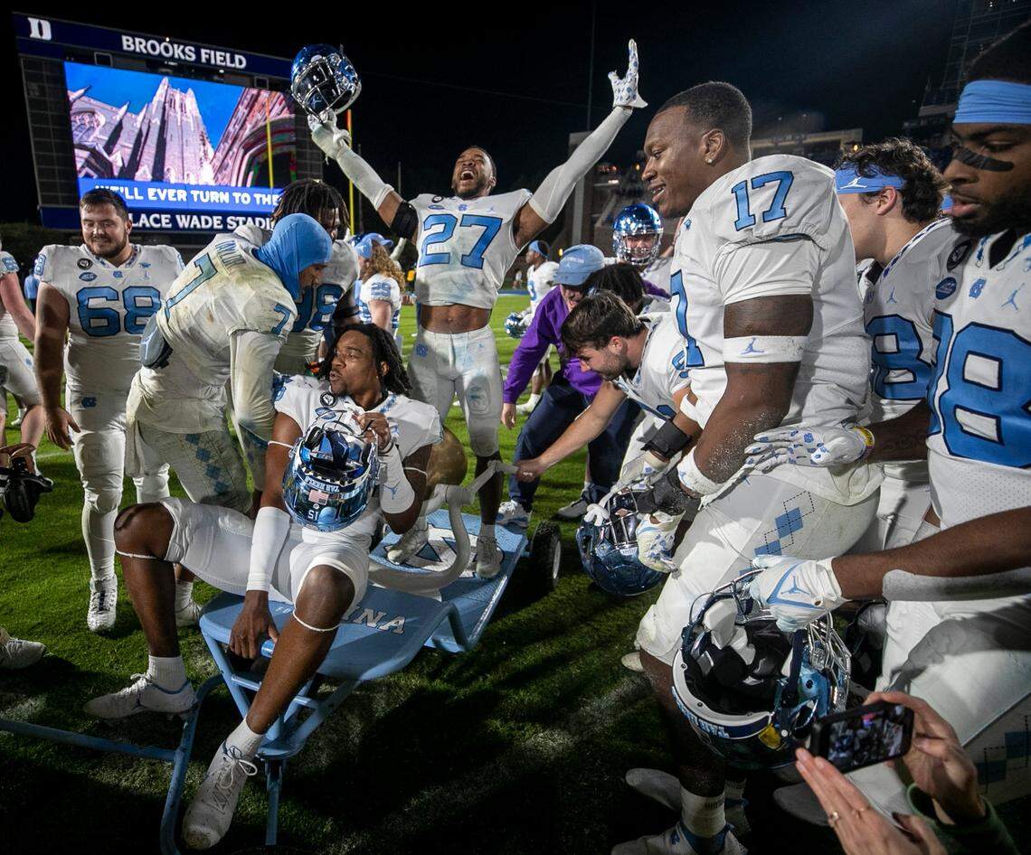 North Carolina’s Giovanni Biggers (27) celebrates with the victory bell and his teammates after their 38-35 victory over Duke on Saturday, October 15, 2022 at Wallace-Wade Stadium in Durham, N.C.