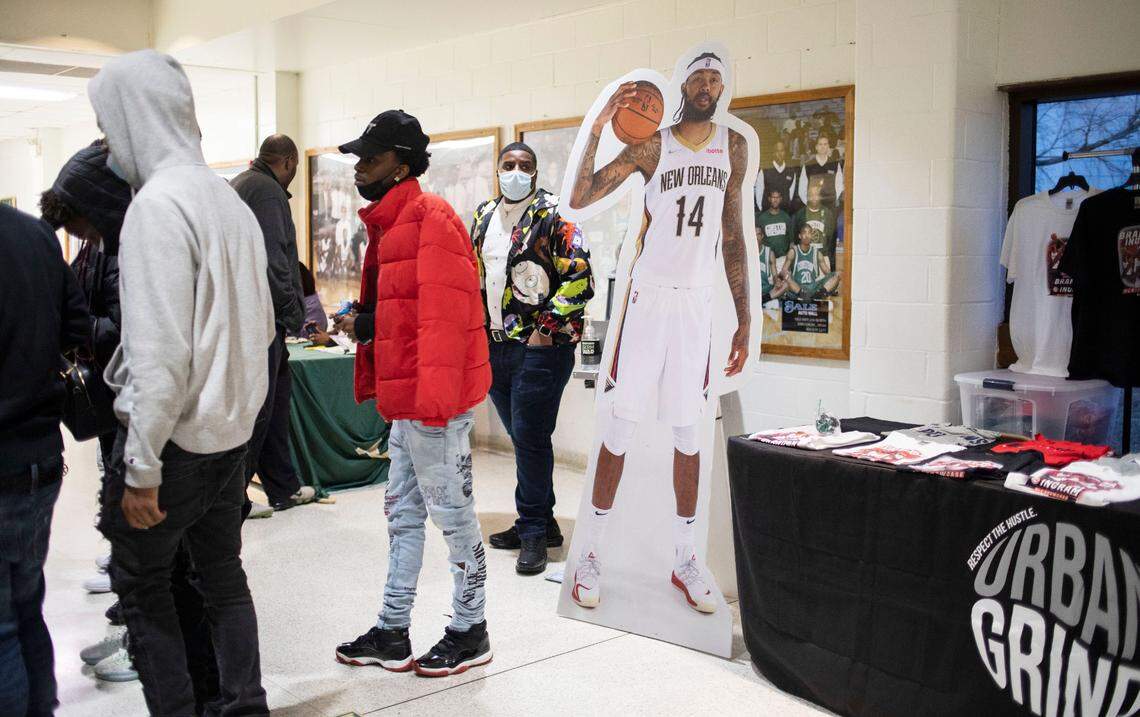 Basketball fans file into the gym at Kinston High School near a cardboard cutout of Brandon Ingram, a former Kinston High basketball player who now plays for the New Orleans Pelicans in the NBA, during the inaugural Brandon Ingram MLK Showcase in Kinston, N.C. on Saturday, Jan. 15, 2022.