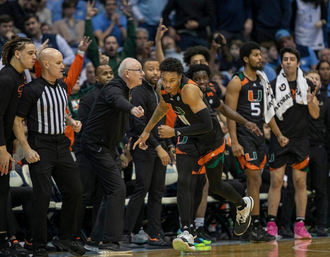 Miami’s Jordan Miller (11), coach Jim Larranaga, react after a three point basket by Miller to give the Hurricanes’ a 12 point lead in the second half against North Carolina on Monday, February 13, 2023 at the Smith Center in Chapel Hill, N.C. Miller lead all scores with 24 points in Miami’s 80-762 victory.