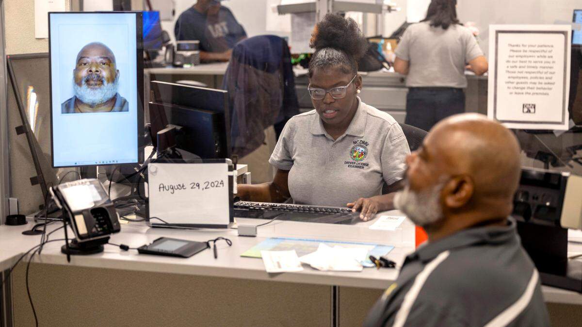 Examiner Tya Barnes makes Sidney Tindall Jr.’s photo for a new drivers license at the NC DMV driver license office on New Bern Avenue in Raleigh in a file photo from Aug.. 29, 2024.