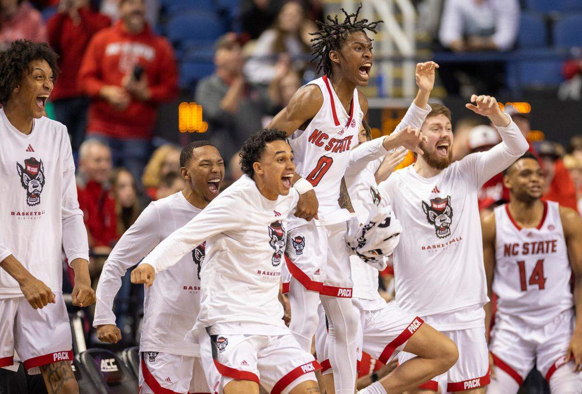 N.C. State’s Terquavion Smith (0) and the Wolfpack bench react after a dunk by Ernest Ross (24) to secure their 97-77 victory over Virginia Tech in the second round of the ACC Tournament on Wednesday, March 8, 2023 at the Greensboro Coliseum in Greensboro, N.C.