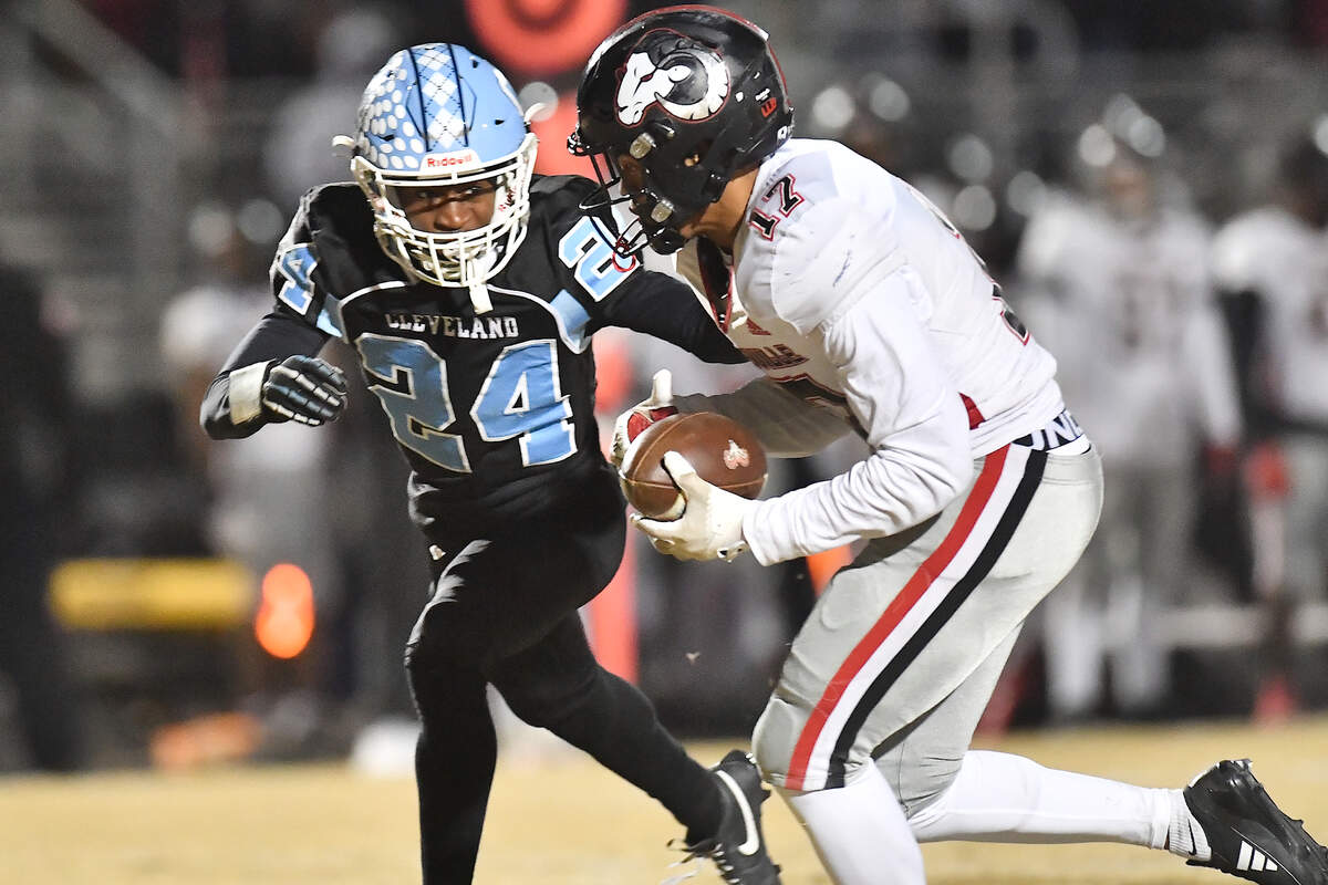 Rolesville’s Jaedon Alford (17) runs for the first down against Cleveland’s Theron Batiste (24) during the second half. The Rolesville Rams and the Cleveland Rams met in the fourth round of the NCHSAA 4A football playoffs in Clayton, N.C. on December 6, 2024.
