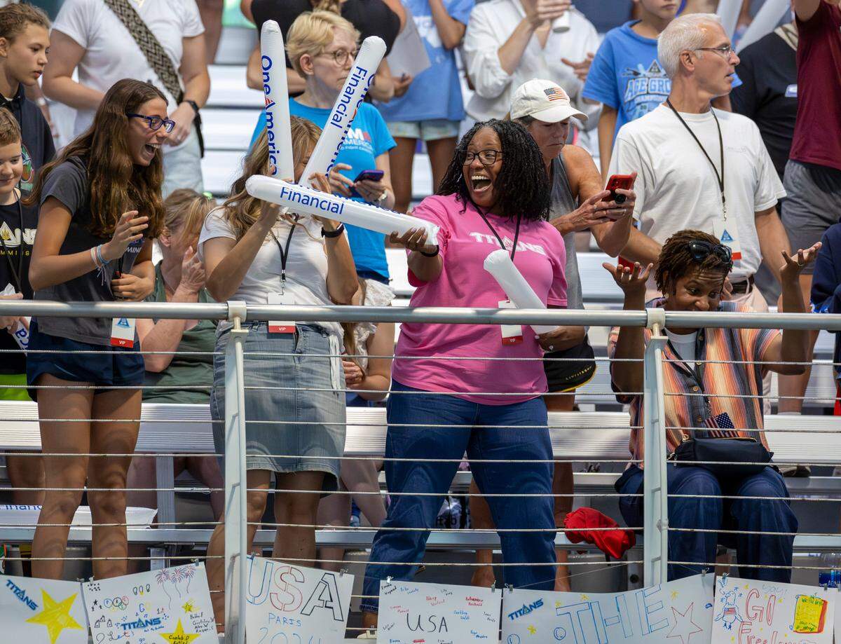 From left, Marlowe Bellerjeau, Darcy Bellerjeau, Faith Crooks and Christine Shearer cheer on the 2024 United States Olympic Swim Team during their open practice on Saturday, July 6, 2024 at the Triangle Aquatic Center in Cary, N.C.