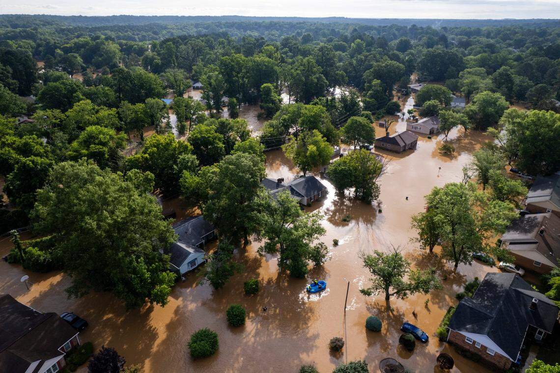 A water rescue unit paddles a raft in the Old Farm neighborhood along the Eno River in Durham on Monday morning, July 7, 2025, after Tropical Storm Chantal caused flash flooding.