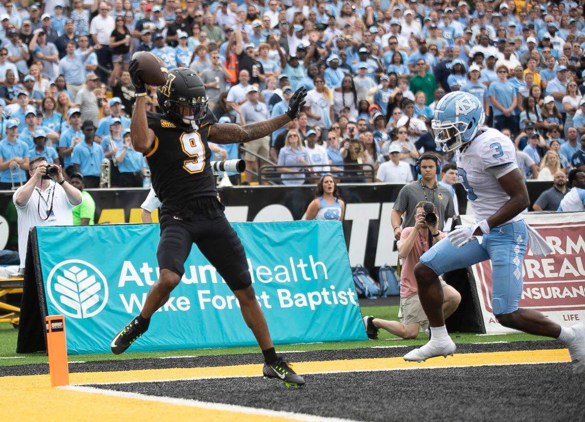 Appalachian State’s Christian Wells (9) pulls in a two yard pass completion for a touchdown ahead of North Carolina’s Storm Duck (3) to take a 21-7 lead in the second quarter on Saturday, September 3, 2022 at Kidd Brewer Stadium in Boone, N.C.