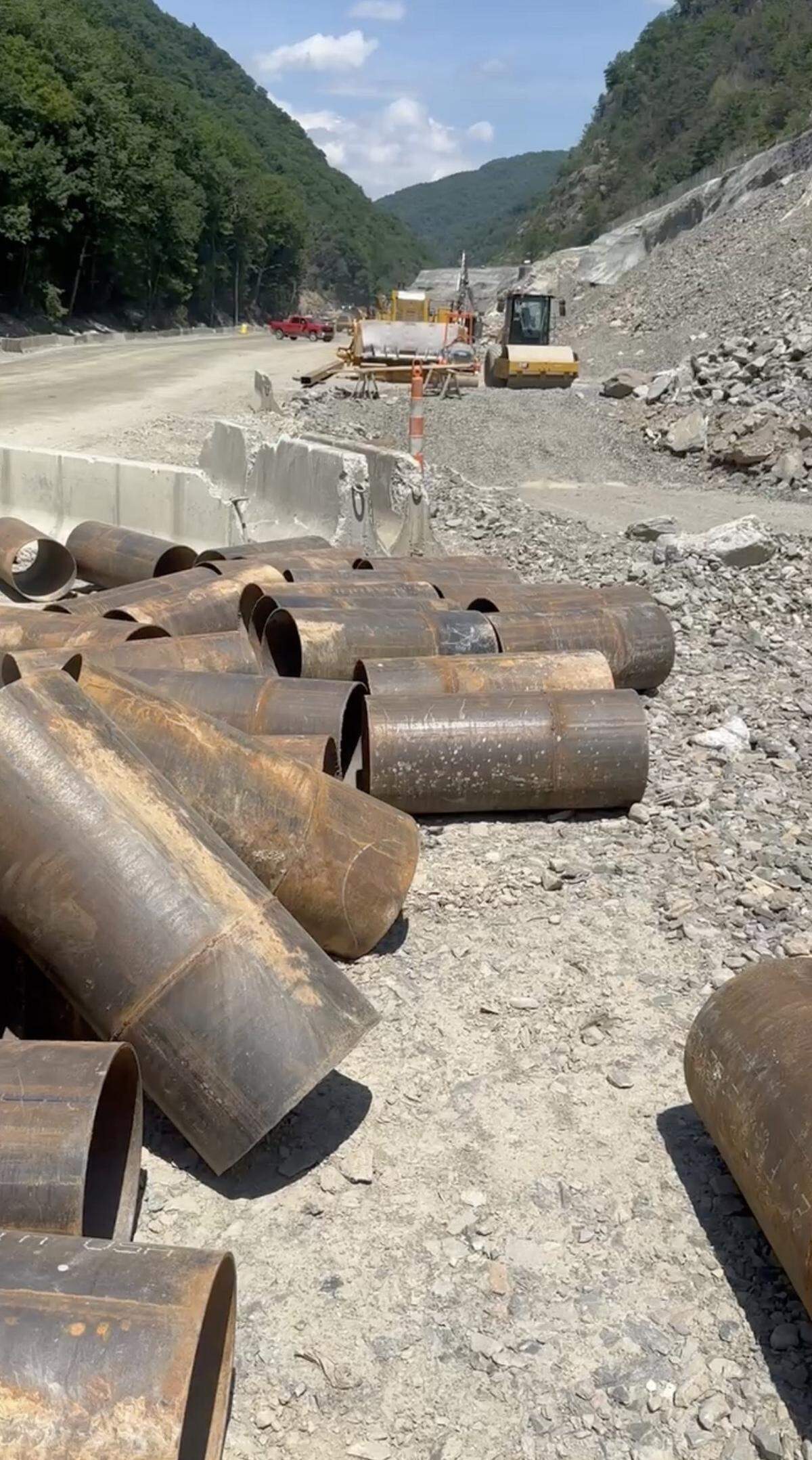 Anything left on the ground for a while can become snake habitat in the Pigeon River Gorge, where workers are rebuilding the eastbound lanes of Interstate 40 destroyed by the remnants of Hurricane Helene.