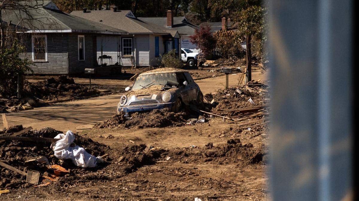 A mud-covered car sits abandoned in the Beacon Village neighborhood in Swannanoa, N.C., on Oct. 25, 2024.