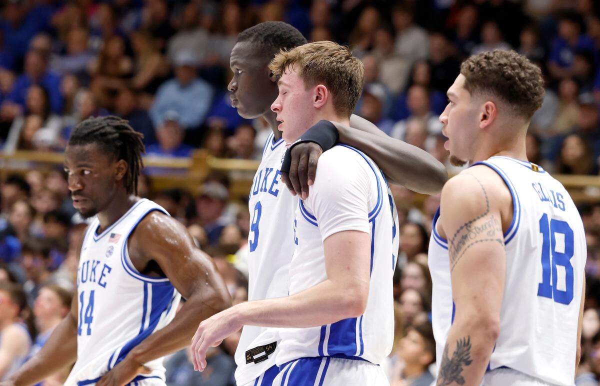 Duke’s Khaman Maluach (9) helps Cooper Flagg (2) back to the bench after he was injured during the first half of Duke’s game against Florida State at Cameron Indoor Stadium in Durham, N.C., Saturday, March 1, 2025.