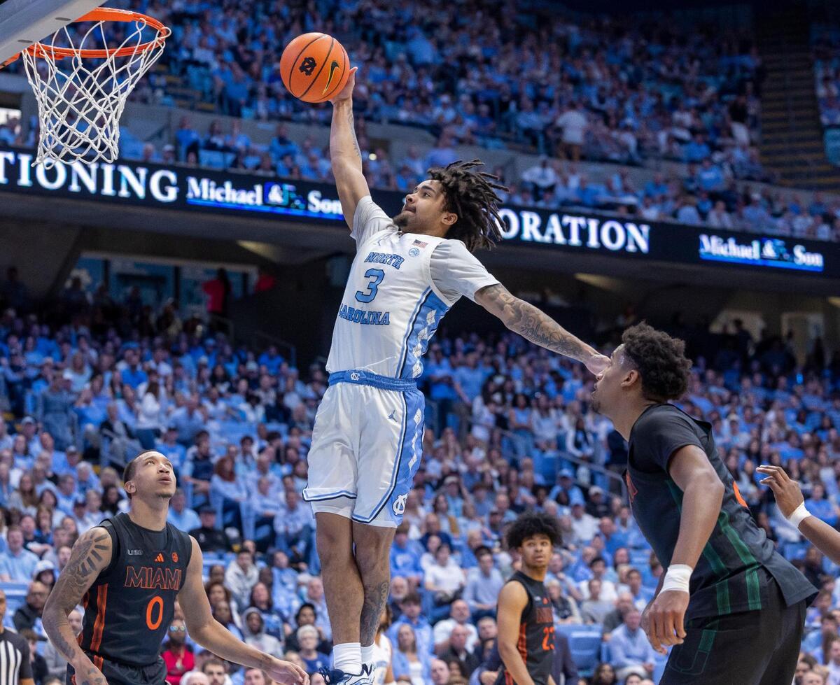 North Carolina guard Elliot Cadeau (3) soars to the basket for a dunk against Miami guard Matthew Cleveland (0) in the second half on Saturday, March 1, 2025 at the Smith Center in Chapel Hill, N.C.
