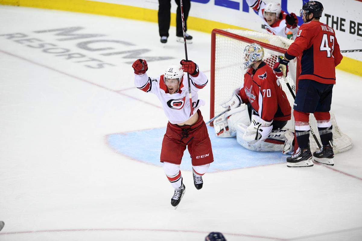Carolina Hurricanes left wing Brock McGinn, left, celebrates his game-winning goal during double overtime of Game 7 of an NHL hockey first-round playoff series against Washington Capitals goaltender Braden Holtby (70) and right wing Tom Wilson (43), Wednesday, April 24, 2019, in Washington. The Hurricanes won 4-3 in double overtime. (AP Photo/Nick Wass)