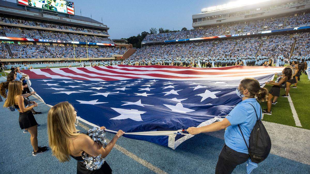 A giant American Flag covers the playing field of Kenan Stadium during the National Anthem prior to the Tar Heels’ game against Georgia State on Saturday, September 11, 2021 Chapel Hill, N.C.