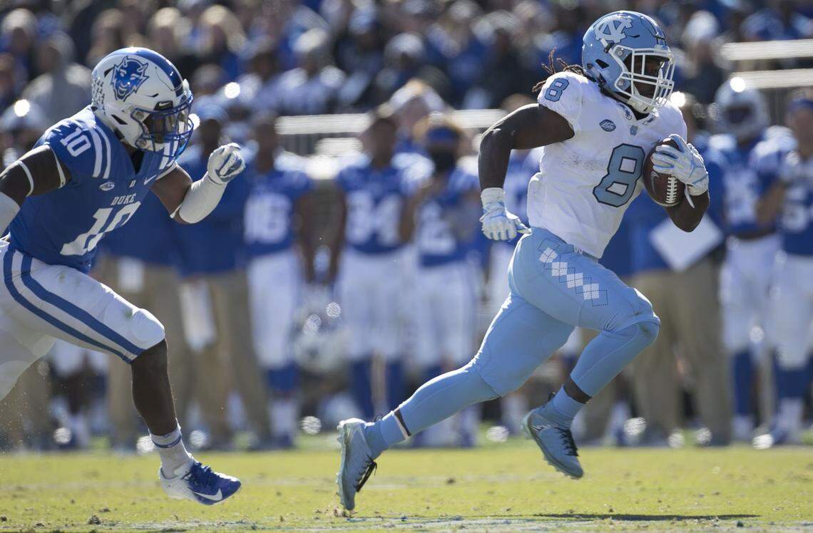 North Carolina’s Michael Carter (8) races ahead of Duke’s Marquise Waters (10) on a 40 yard romp for a touchdown in the first quarter against Duke on Saturday, November 10, 2018 at Wallace Wade Stadium in Durham, N.C.