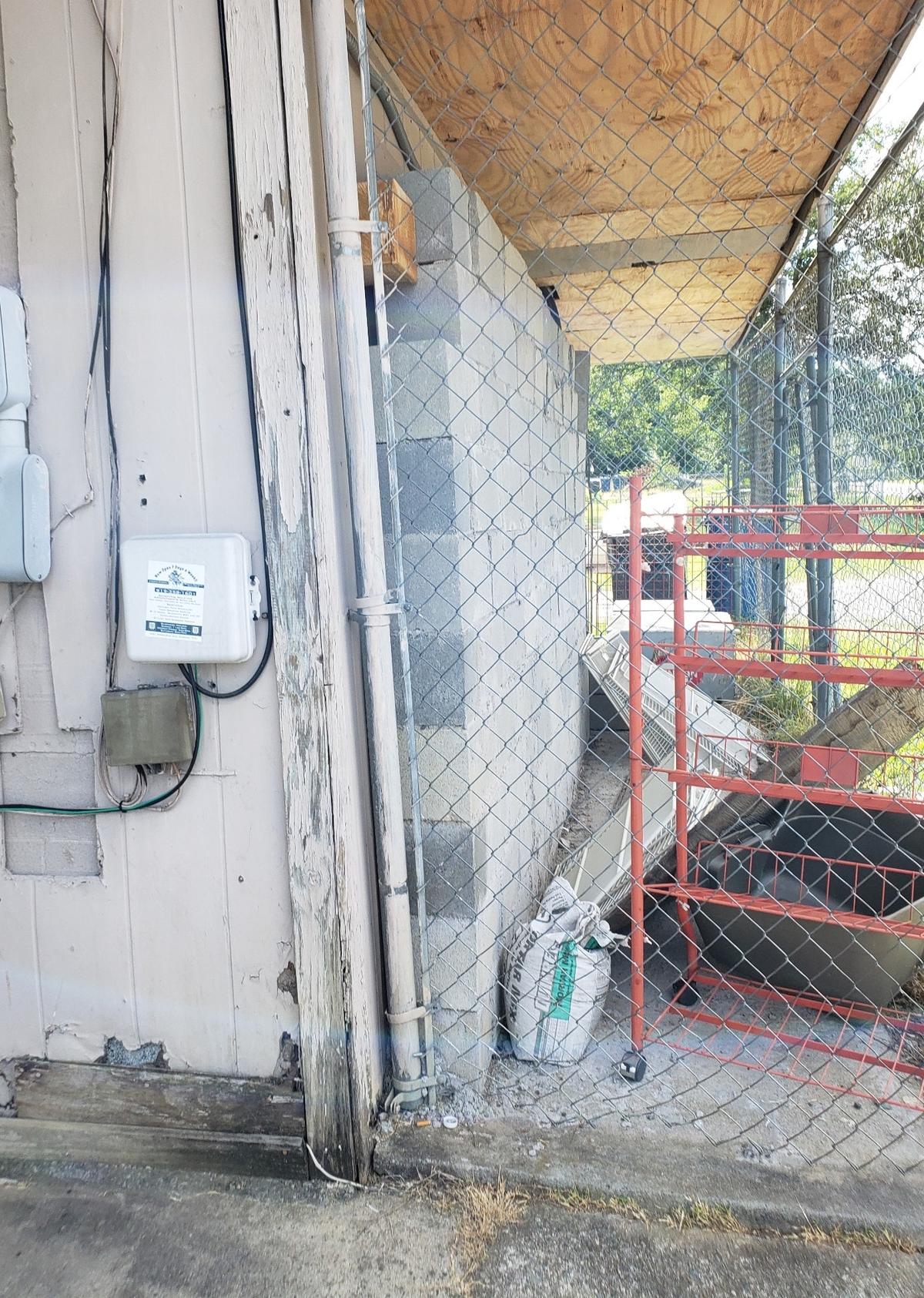 Cinder blocks stacked in front of a wall at Two Brothers mini mart on Dearborn Drive in Durham stop bullets from coming into the store during frequent shootings, a store employee said on June 29, 2021.