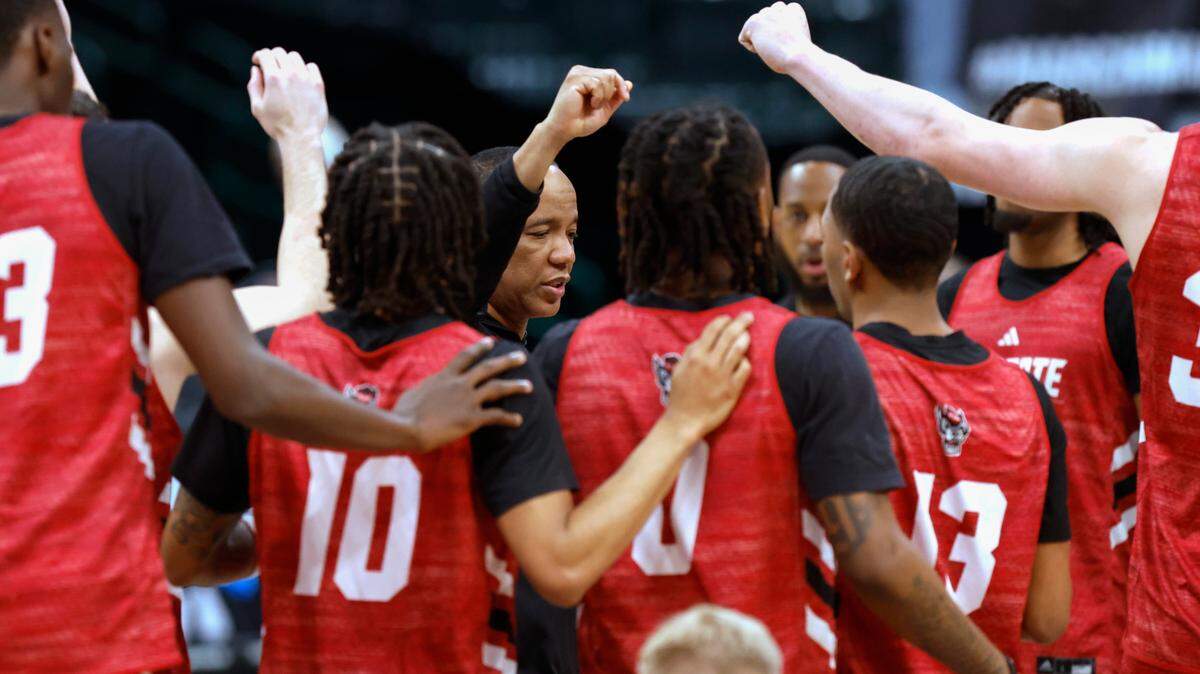 N.C. State head coach Kevin Keatts huddles with the team at the start of the Wolfpack’s practice at the American Airlines Center in Dallas, Texas, Thursday, March 28, 2024. N.C. State will face Marquette in the Sweet 16 of the NCAA Tournament Friday.