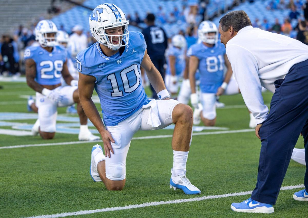 North Carolina quarterback Drake Maye (10) talks with Sparky Woods prior to the Tar Heels’ game against Virginia on Saturday, October 21, 2023 at Kenan Stadium in Chapel Hill, N.C.