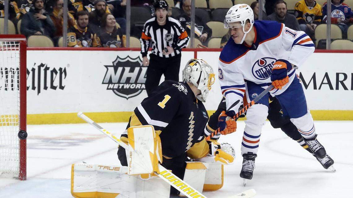 Feb 23, 2023; Pittsburgh, Pennsylvania, USA; Edmonton Oilers right wing Jesse Puljujarvi (13) hits the post behind Pittsburgh Penguins goaltender Casey DeSmith (1) during the third period at PPG Paints Arena. Edmonton won 7-2. Mandatory Credit: Charles LeClaire-USA TODAY Sports