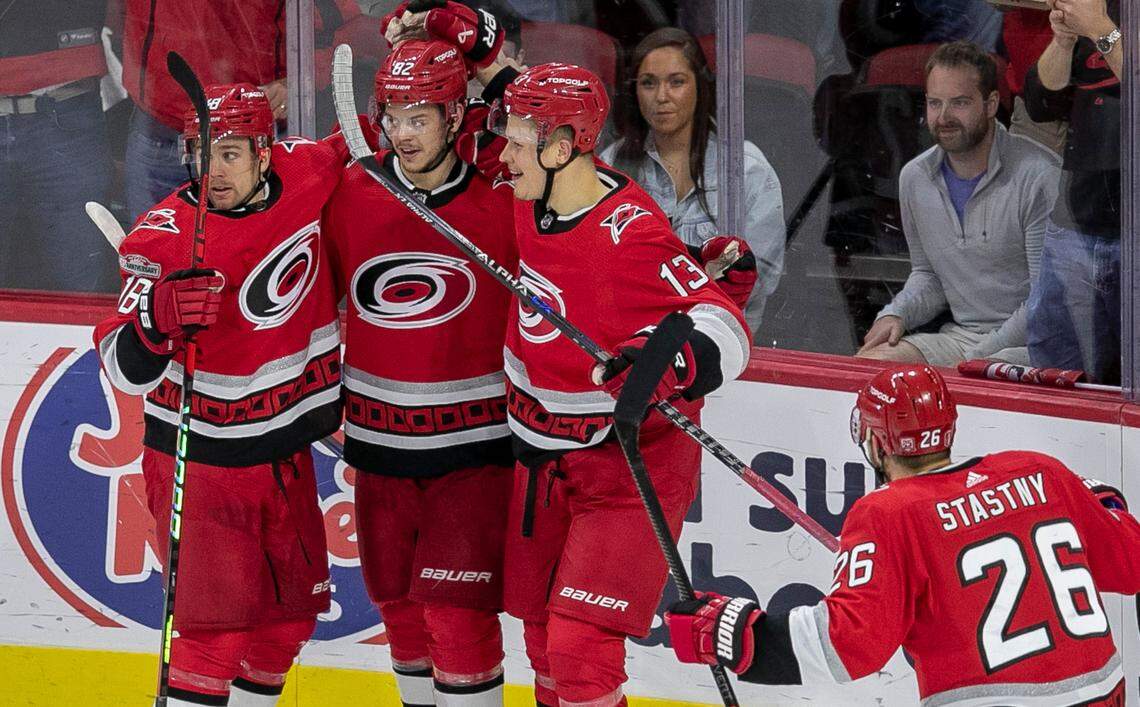 The Carolina Hurricanes Jack Drury (18) and Jesse Piljujarvi (13) congratulate Jesperi Kotkaniemi (82) after he scored the first of two goals against the New Jersey Devils goalie Akira Schmid (40) in the second period during Game 2 of their second round Stanley Cup playoff series on Friday, May 5, 2023 at PNC Arena in Raleigh, N.C.