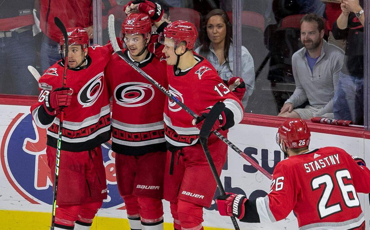The Carolina Hurricanes Jack Drury (18) and Jesse Piljujarvi (13) congratulate Jesperi Kotkaniemi (82) after he scored the first of two goals against the New Jersey Devils goalie Akira Schmid (40) in the second period during Game 2 of their second round Stanley Cup playoff series on Friday, May 5, 2023 at PNC Arena in Raleigh, N.C.