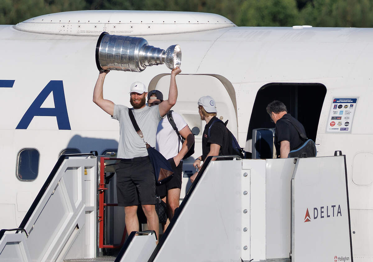 Jordan Staal holds the Stanley Cup aloft as the Carolina Hurricanes arrive to Raleigh-Durham International Airport on Monday, June 15, 2026.