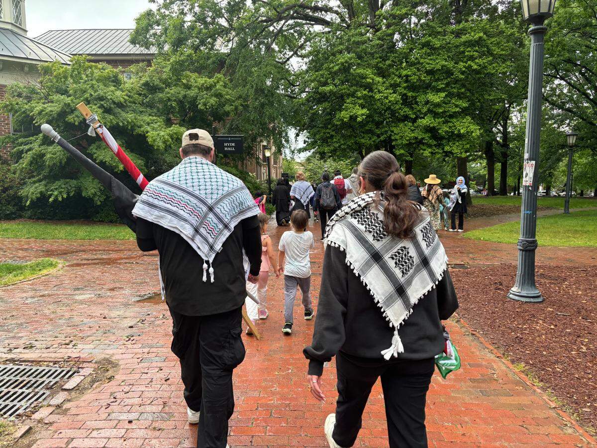 Two pro-Palestinan protesters with keffiyehs leave Polk Place on the campus of UNC-Chapel Hill on MAy 5, 2024.
