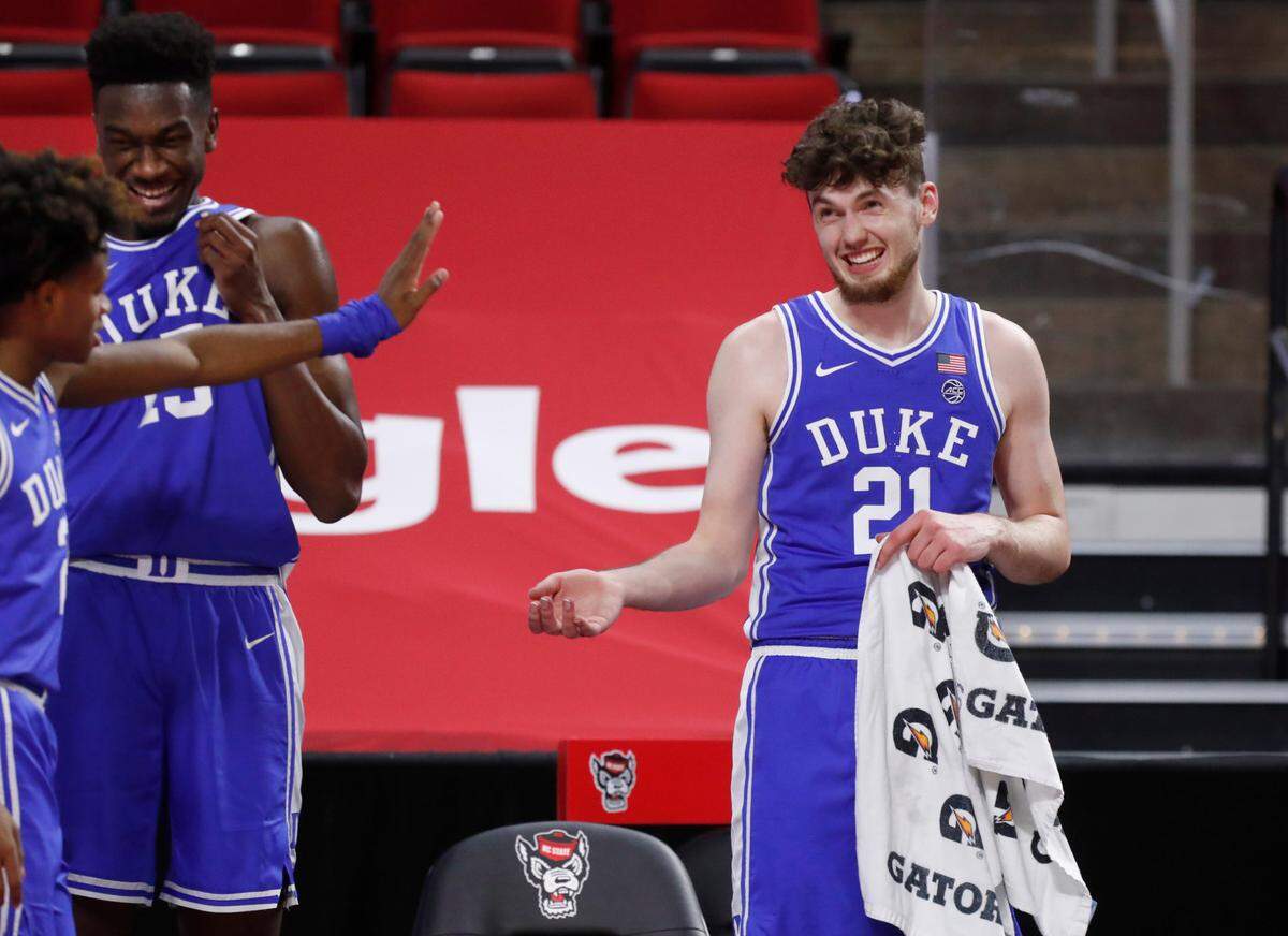 Duke’s Matthew Hurt (21) laughs with DJ Steward (2) and Mark Williams (15) during the second half of Duke’s 69-53 victory over N.C. State at PNC Arena in Raleigh, N.C., Saturday, February 13, 2021.