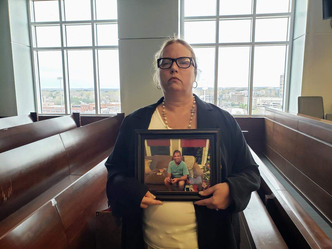 Teddy Tivnan’s sister Carol Reardon holds a photo of him before court starts on March 29, 2022. Daniel Mohar, the man charged with killing Tivnan was sentenced after pleading to involuntary manslaughter.