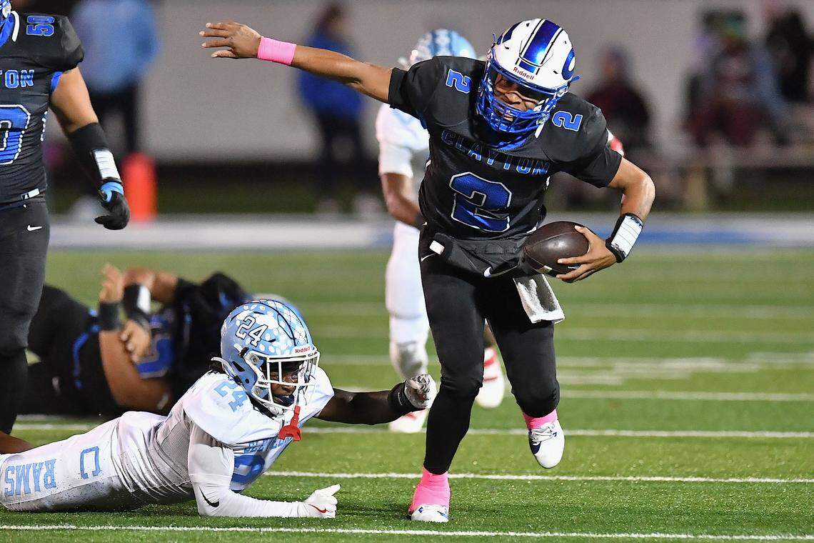 Clayton quarterback Aiden Smalls (2) runs away from Cleveland linebacker Diondre Haynes during the first half. The Cleveland Rams took on the Clayton Comets in a conference football game in Clayton, N.C. on October 31st in Clayton, N.C.