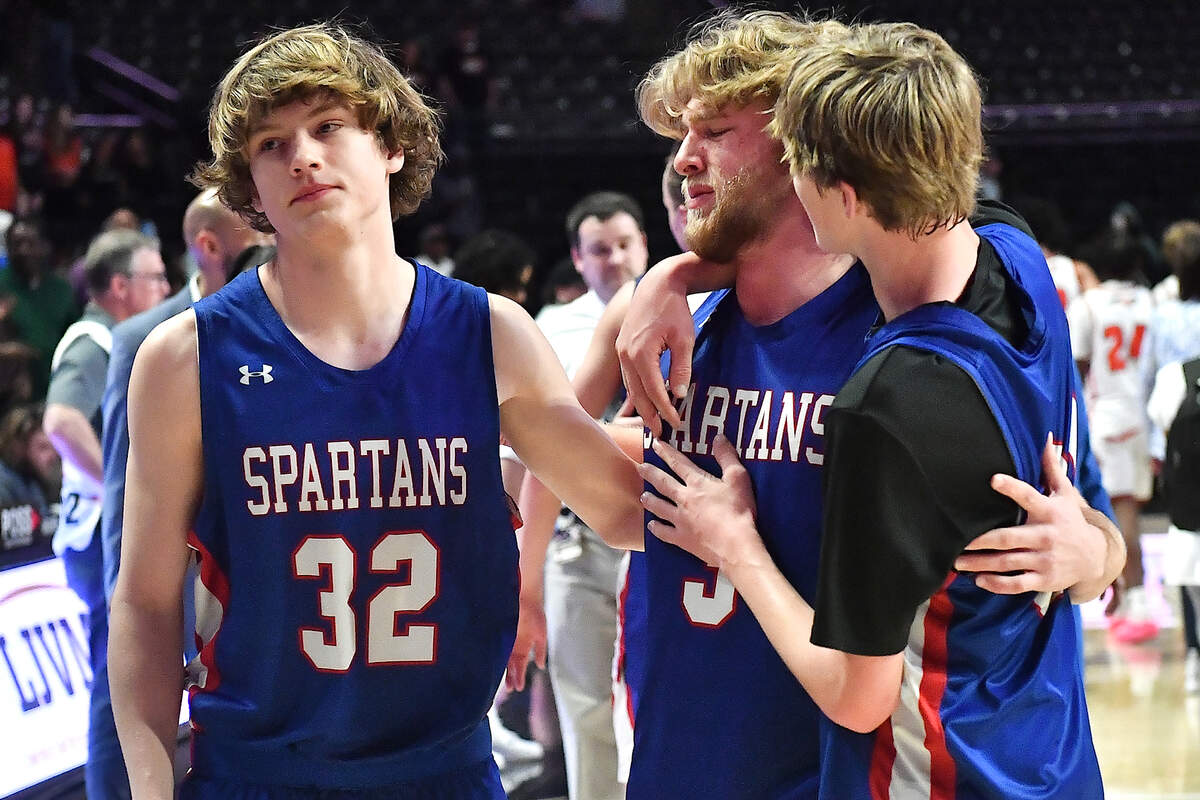 Sanderson’s Jacob Wright (32) , Benjamin Ellison (3) and Mack Snavely (31) react after their loss to New Hanover in the East Regional Finals. The Sanderson Spartans and the New Hanover Wildcats met in the NCHSAA 4A East Regional Final in Winston-Salem, N.C. on March 12, 2025.
