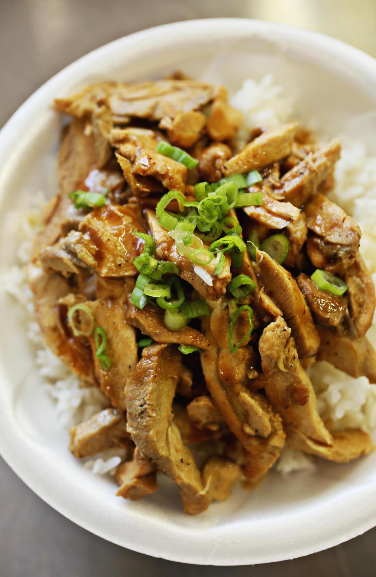 Ron Blancaflor’s chicken adobo is served over rice at Adobo Joe. Or you can get it topped with slaw on a toasted bun.
