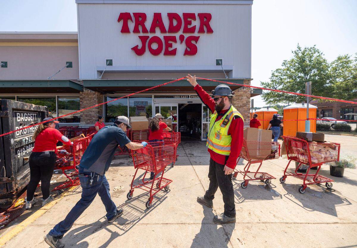 A small army of contract workers remove and discard everything from the flooded Trader Joe’s store in Eastgate Shopping Center on Tuesday, July 8, 2025 in Chapel Hill, N.C. Most of the businesses in Eastgate were flooded by heavy rain from Tropical Storm Chantal on Sunday.
