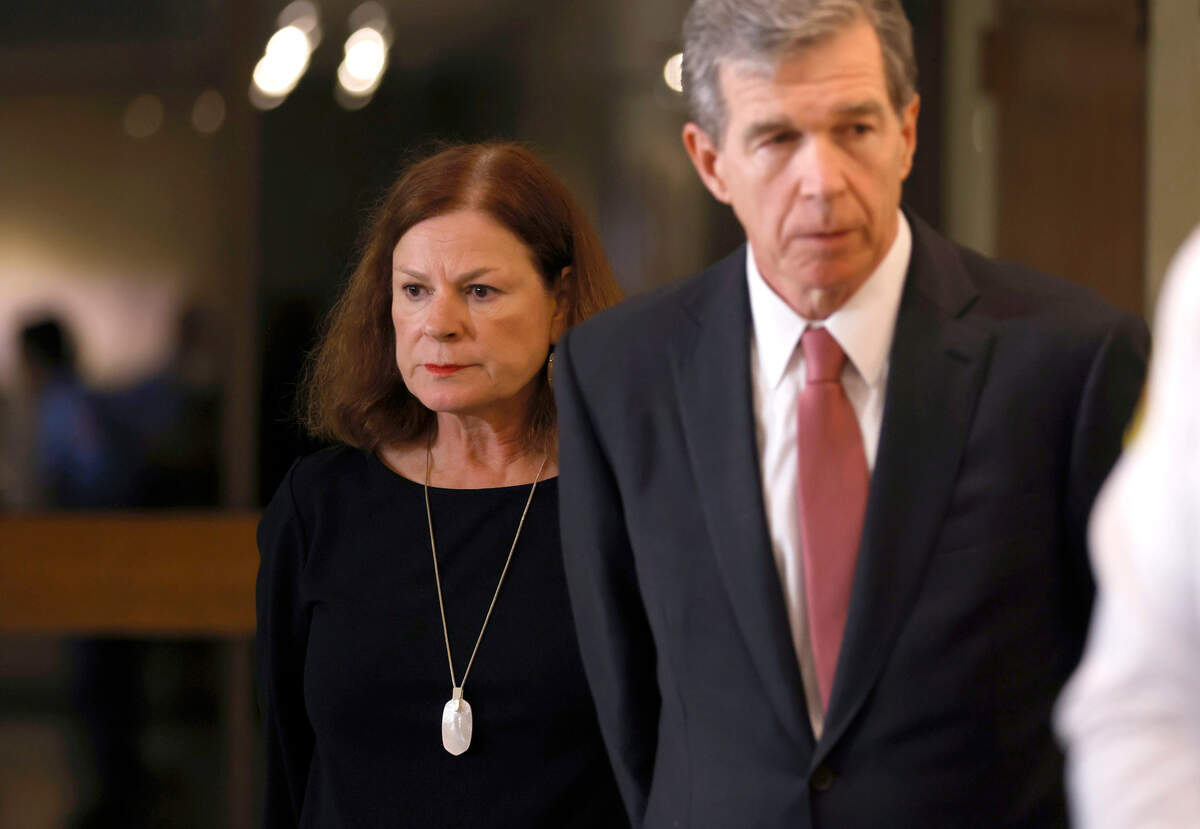 Raleigh Mayor Mary-Ann Baldwin and North Carolina Gov. Roy Cooper listen during a press briefing about a shooting that left five people dead, including an off-duty police officer, on Thursday, Oct. 13, 2022, in Raleigh, N.C.