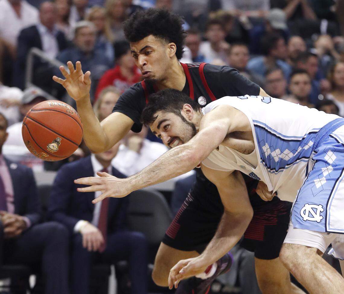 Louisville’s Jordan Nwora (33) tries to steal the ball from North Carolina’s Luke Maye (32) during the first half of UNC’s game against Louisville in the quarterfinals of the 2019 ACC Tournament in Charlotte, N.C., Thursday, March 14, 2019.