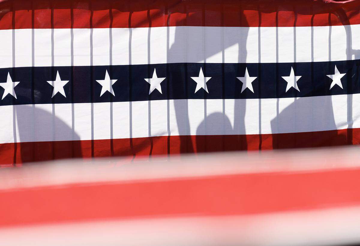 Supporters hold signs during a rally held by former President and current Republican candidate for president Donald Trump in Wilmington, N.C. on Saturday, Sept. 21, 2024.