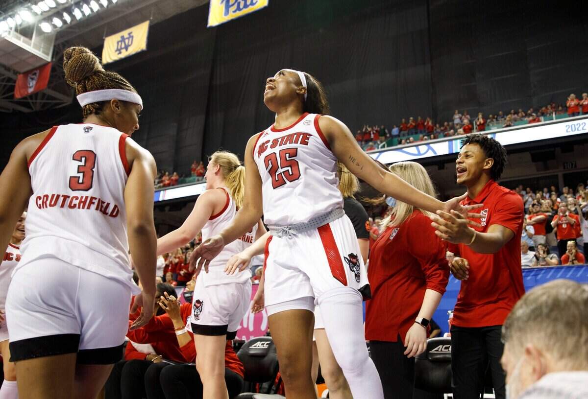 North Carolina State forward Kayla Jones (25) celebrates as she comes off the court with Kai Crutchfield (3) during the second half of an NCAA college basketball game against Virginia Tech in the semifinals of the Atlantic Coast Conference women’s tournament in Greensboro, N.C., Saturday, March 5, 2022. (AP Photo/Lynn Hey)